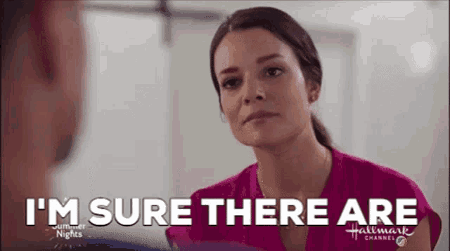 a woman in a pink shirt is talking to a man in a hallmark channel ad .