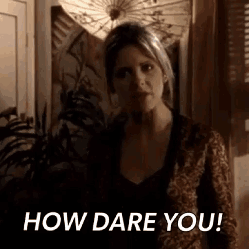 a woman is standing in a room with an umbrella in the background and a sign that says `` how dare you '' .