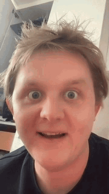 a close up of a man making a funny face with his mouth open
