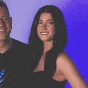 a man and a woman are posing for a picture and smiling