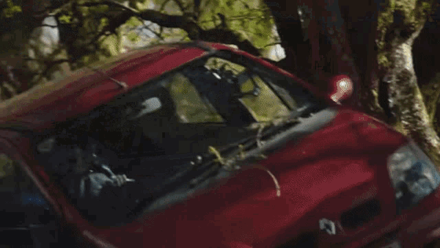 a man driving a car with a steering wheel in his hand