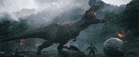a t-rex dinosaur is eating a man in a field in a movie .