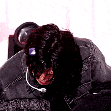 a person wearing a denim jacket with the letters vbrc on the front