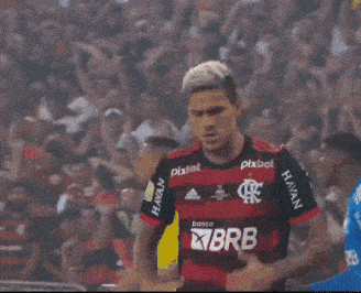 a soccer player wearing a shirt that says brb is dancing on the field
