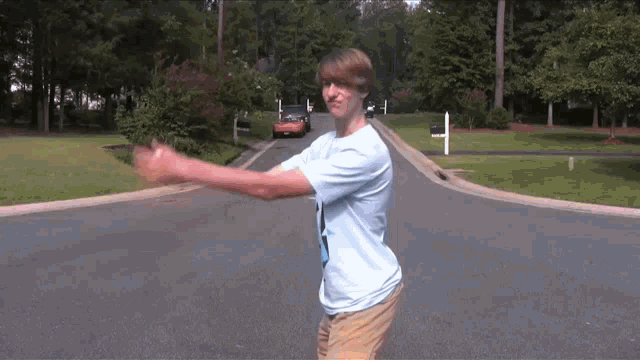 a man wearing a blue shirt with the number 3 on it is walking down a street