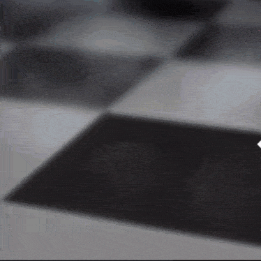 a black and white checkered floor with a arrow pointing to the right