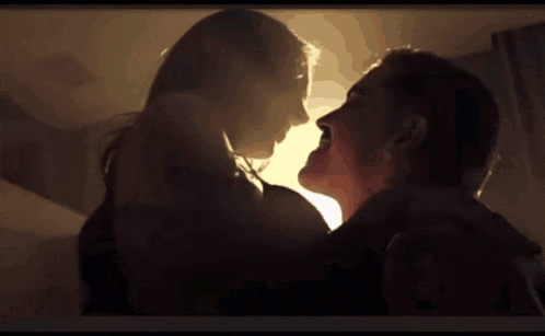 a man and a woman are kissing and the man is screaming