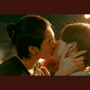 a man and a woman are kissing each other .