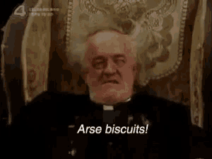 a priest is sitting in a chair and saying arse biscuits .
