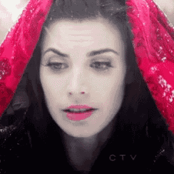 a woman wearing a red scarf over her head with ctv written on the bottom right