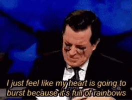 a man in a suit and tie is talking about how his heart is going to burst because it is full of rainbows