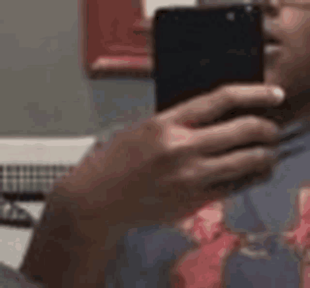 a man is taking a selfie with a cell phone .