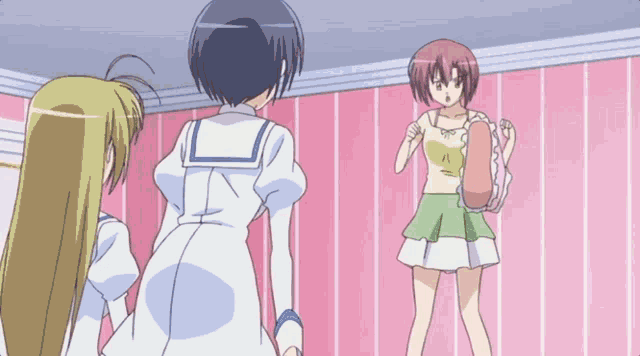 three anime girls are standing in front of a pink wall and one of them is wearing a green skirt