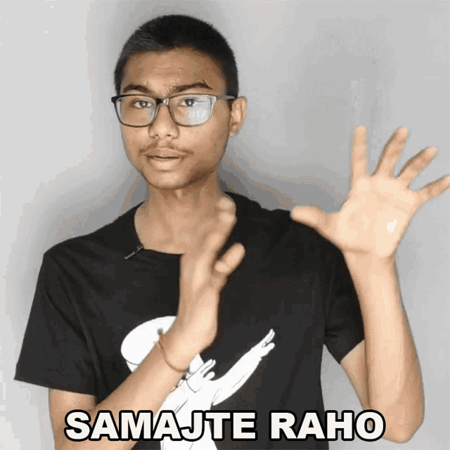 a man wearing glasses and a black shirt with the words samajte raho on it