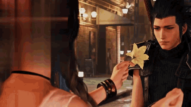 a man is giving a flower to a woman