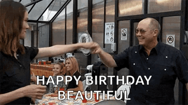 a man and woman are giving each other a high five .