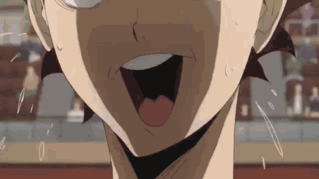 a close up of a person 's face with their mouth open .
