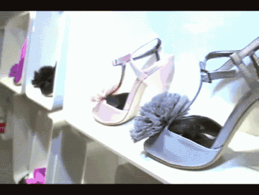 a pair of purple shoes with a flower on the toe