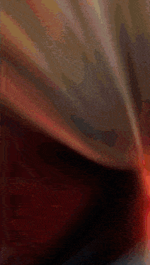a blurred image of a red light coming out of a black hole