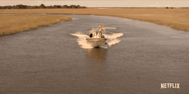 a boat is going down a river with a netflix logo in the background