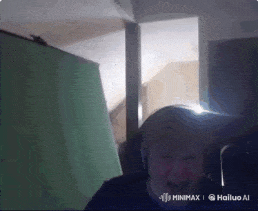 a man is screaming in front of a green screen that says minimx on the bottom