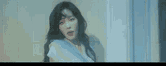 a close up of a woman 's face with a blurry background .