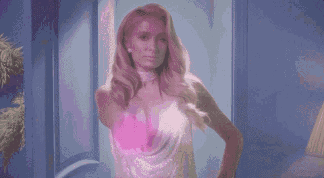 a woman in a white dress is standing in a doorway