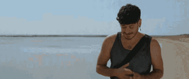 a man praying on a beach with his eyes closed