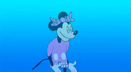two men in pink shirts are standing in front of a minnie mouse icon .