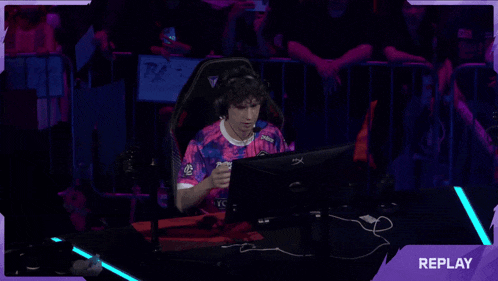 a man wearing a pink and blue shirt that says youc1000