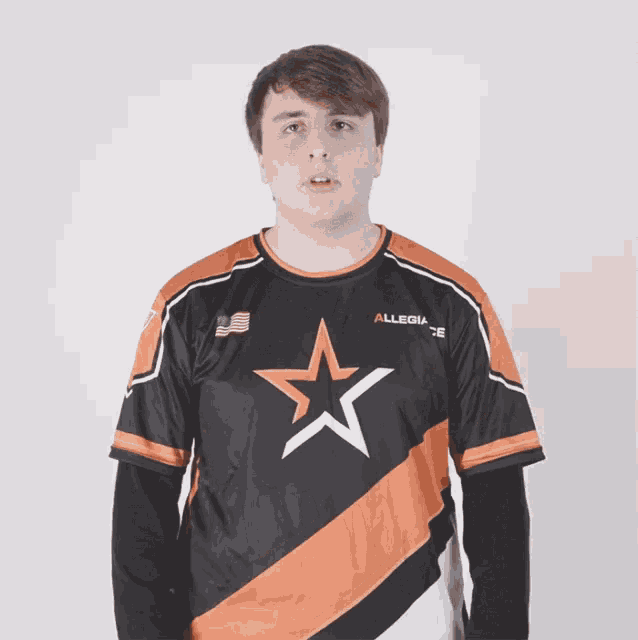 a young man wearing an allegiance jersey with a star on the front