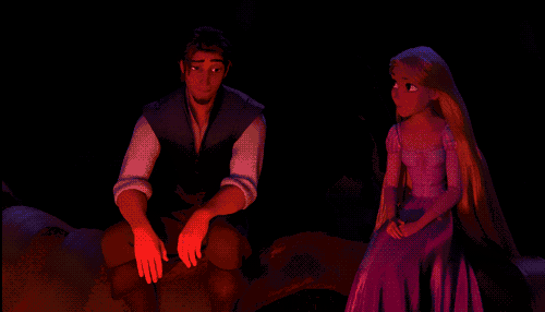 a man and a woman sit next to each other in a dark room