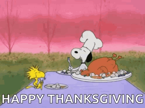 snoopy and woodstock are sitting at a table with a plate of food and a turkey on it .