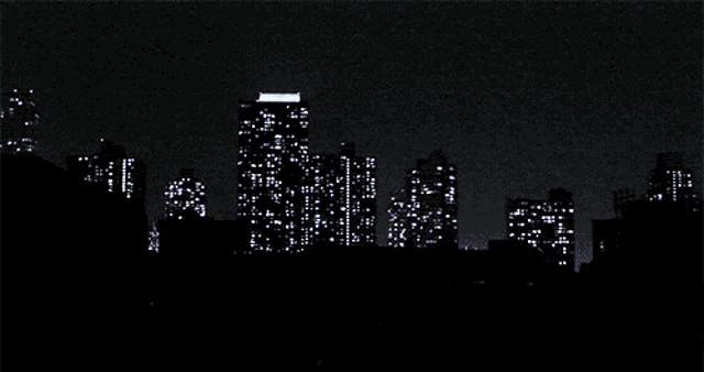 a silhouette of a city skyline with the sun shining through the buildings