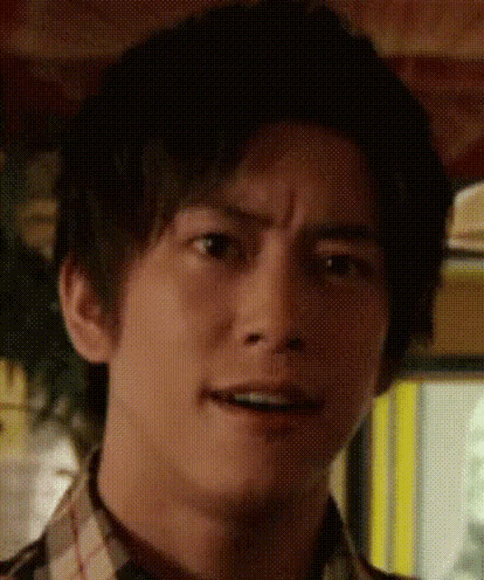 a close up of a man 's face with a grid pattern on it making a funny face .
