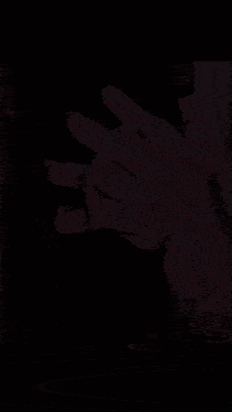 a close up of a person 's face with their hands on it