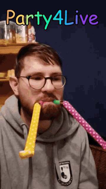 a man with glasses and a beard is blowing party horns with the words party4live written above him