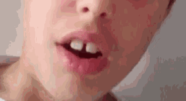 a close up of a child 's mouth with a tooth missing .
