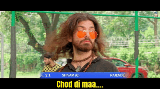 a man with long hair and a beard is wearing sunglasses and a necklace and says chod di maa on the screen