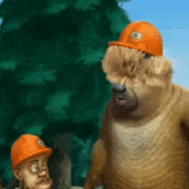 a bear wearing a hard hat is standing next to a man wearing a hard hat .