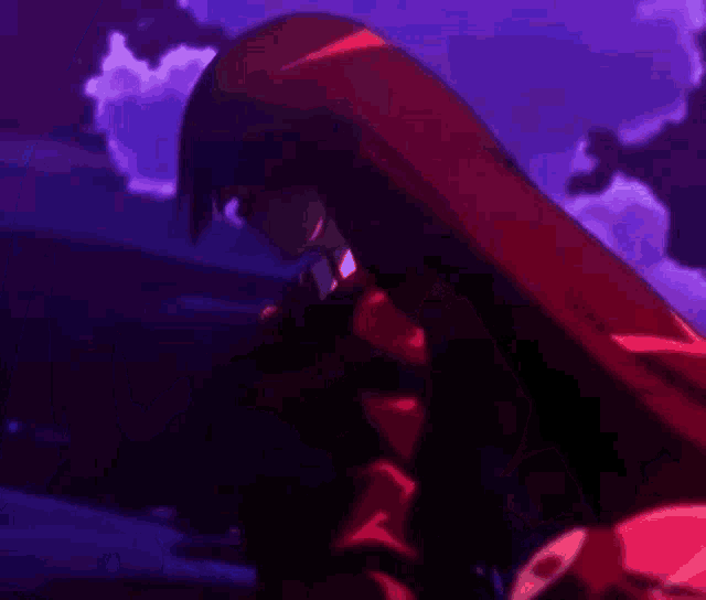 a girl with long red hair is standing in the dark .