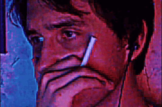 a man is smoking a cigarette and covering his mouth