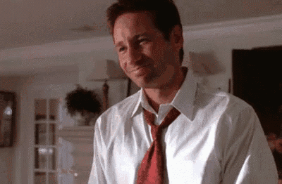 a man wearing a white shirt and red tie is smiling .