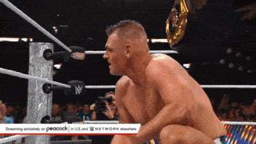 a man in a wrestling ring with a peacock logo