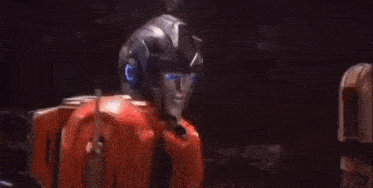 a close up of a robot with blue eyes and a helmet .
