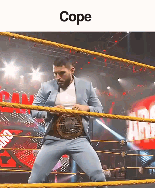 a man in a suit is standing in a wrestling ring with the caption cope above him