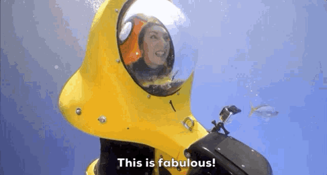 a woman is in a yellow submarine and says this is fabulous .