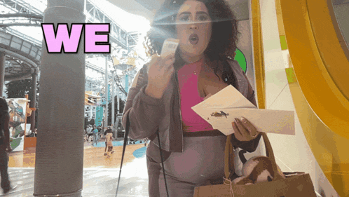 a woman holding a piece of paper with the word we above her head