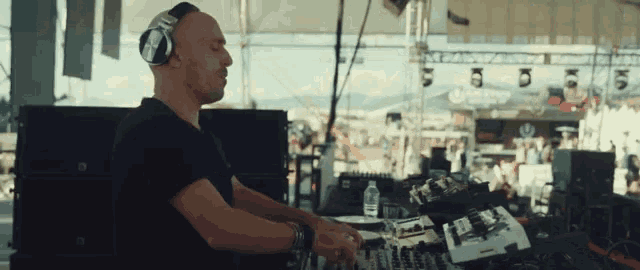 a man wearing headphones is playing music at a concert