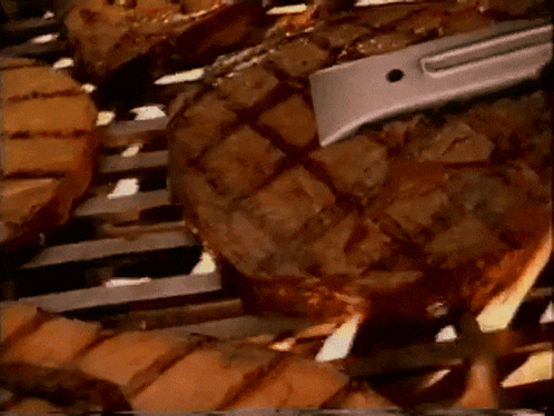 a close up of a steak being grilled on a grill